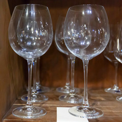Handmade glass glasses are on the shelf of the store.