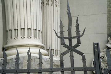 Obraz premium Weathered metal post finials Trident metal fence for protection against chimeras and evil power.