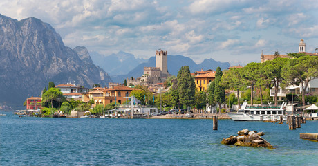 Malcesine - The promenade over the Lago di Garda lake with the town and castle in the background. - obrazy, fototapety, plakaty