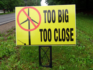 A sign suggesting that electric power windmills are too big and too close to homes.