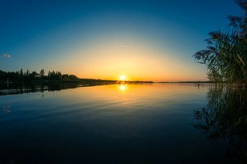 Fototapeta na wymiar Colorful sunset behind a calm lake