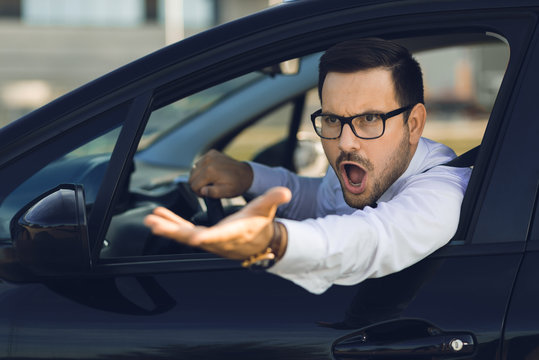 Angry businessman yelling out car window