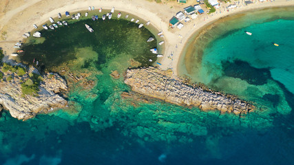 Aerial drone view of iconic sandy turquoise organised with sun beds and umbrellas beach of Paliouri...