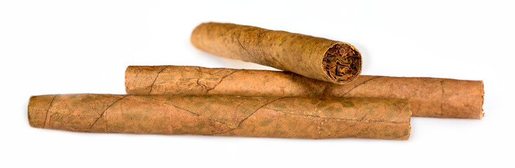 Three tobacco cigarillos isolated on white background. Macro close up, high resolution.