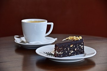 Slice of chocolate cake and cup of coffee. Coffee shop concept