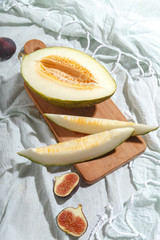 Ripe appetizing melon on a cutting board. Top view