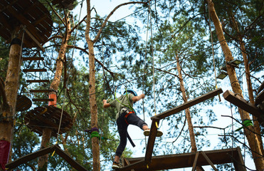 Ten aged boy is on a rope park
