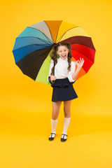 Fancy schoolgirl. Girl with umbrella. Rainy day. Happy childhood. Rainbow style. Kid happy with umbrella. Fall weather forecast. Fashion accessory. Rainy september. Accessory for rainy day. Stay dry