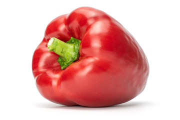 One whole red bell pepper with green stem isolated on white background