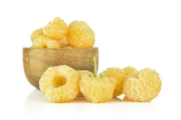 Lot of whole fresh golden hymalayan raspberry in wooden bowl isolated on white background
