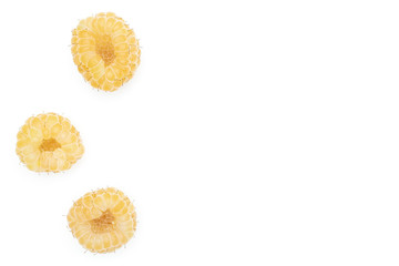 Group of three whole fresh golden hymalayan raspberry copyspace on right flatlay isolated on white background