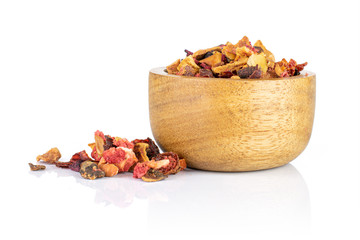 Lot of pieces of dry lavender strawberry ice tea in wooden bowl isolated on white background