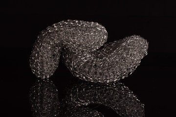 Group of two whole iron cleaning kitchen sponge isolated on black glass