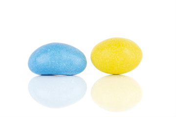 Group of two whole sugared nut dragee blue yellow isolated on white background