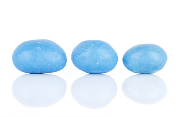 Group of three whole blue sugared nut dragee isolated on white background
