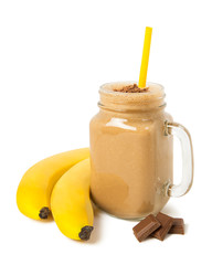 Banana chocolate smoothie in a glass jar with ingredients Isolated on a white background