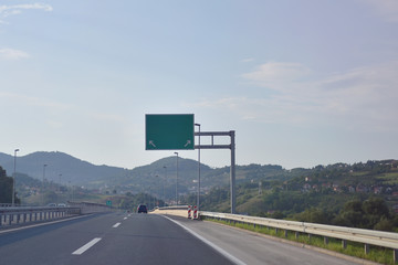 Highway and  road signs at cloudy day.