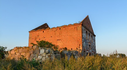 The building of the first manufactory stands on the outskirts of the village in the field.The building is red brick and stone. Ancient building in Belarus. Sights of Belarus.Sights of the Brest region