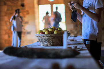 Actual photo shoot in the castle of Guedelon in Treigny (France), photographing apples in a basket...