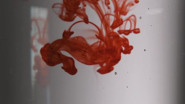 Blood Falling Through Clear Liquid Close Up