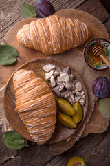 Freshly baked croissants with custard on wooden boards. Free space for text.