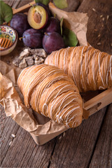 Freshly baked croissants with custard on wooden boards. Free space for text.