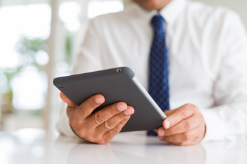 Close up of middle age business man using tablet