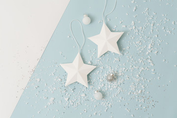 White christmas tree stars and balls sprinkled with snow imitation over blue