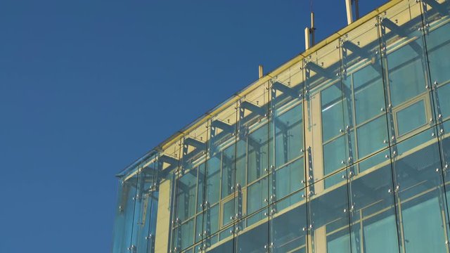 Glass Curtain Facade Wall Tilt Up on Roof Cellular Antennas. Fasteners Elements of Spider Glass System. Facade Detail. Architecture Abstract Background.