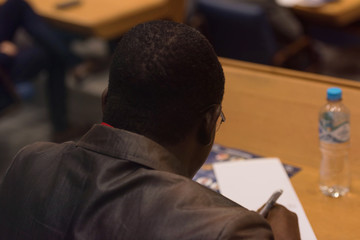 Businessman at business conference room with public giving presentations. Audience at the...
