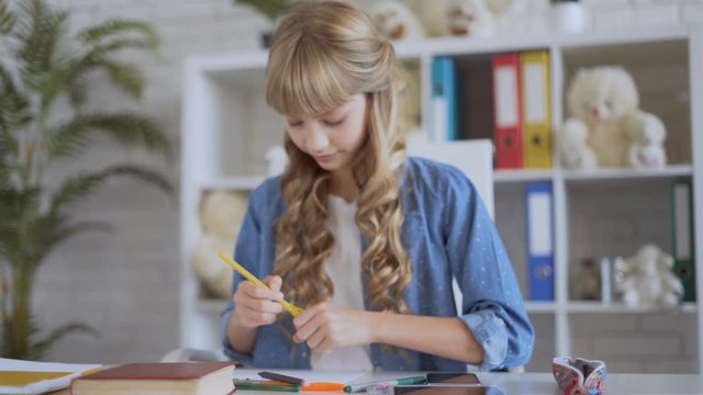 cute girl draws with crayons. 4K