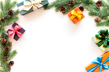 Frame from gifts in boxes and spruce for new year eve on white background top veiw mockup
