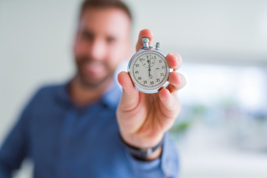 Handsome man showing stopwatch