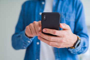 Close up of man hands using smartphone and smiling