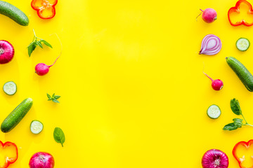 Cook frame with fresh vegetables on yellow background top view space for text