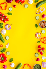 Sliced, cut, chopped vegetables frame on yellow background top view copyspace