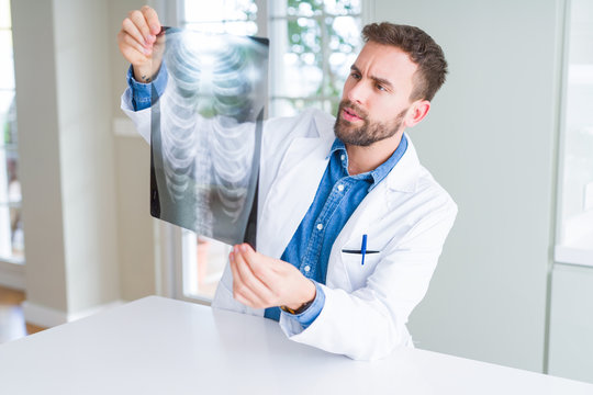 Doctor man looking at x-ray radiography doing body examination