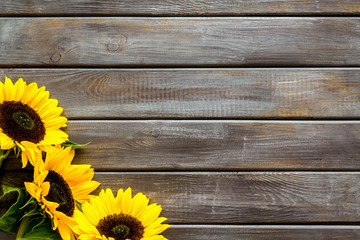 Beautiful yellow sunflowers frame on wooden background top view mock-up