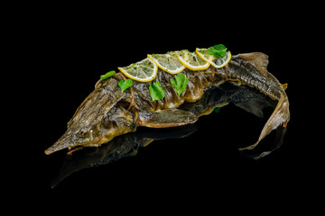 baked catfish on black glass with reflection