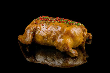 Baked duck on black glass with reflection