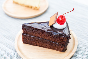 Delicious chocolate cake on plate on table background