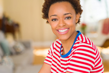 Beautiful young african american woman smiling confident to the camera showing teeth