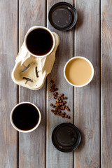Caution: contents hot. Coffee to go on wooden background top view