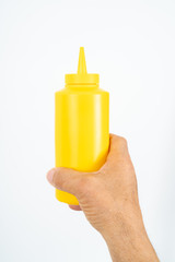 hand holding plastic ketchup box