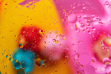 Abstract macro molecular pattern of colored oil bubbles on water. 