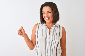 Young beautiful woman wearing casual striped shirt standing over isolated white background doing happy thumbs up gesture with hand. Approving expression looking at the camera with showing success.