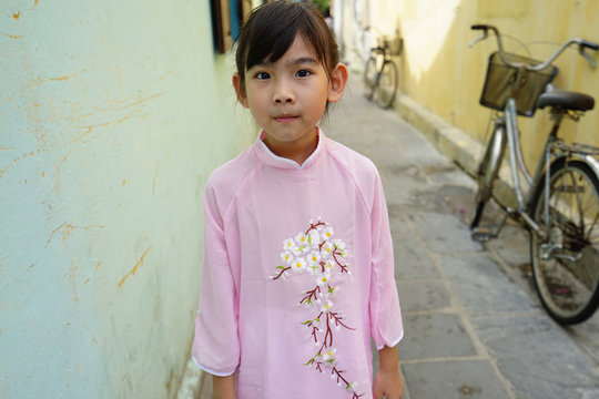 Portrait Asian cute little girl Wear Vietnam national costume Ao dai