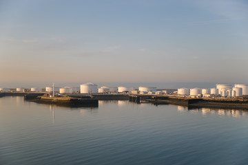 Fototapeta na wymiar Fuel and oil storage tanks along the water at the port of Le Havre