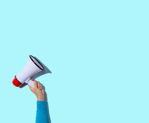 Person holding a megaphone with hard shadow