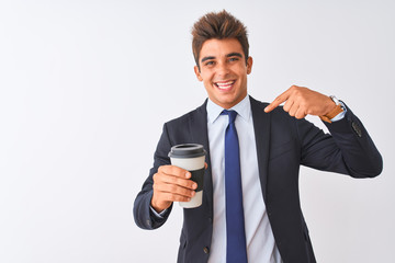 Young handsome businessman wearing suit holding coffee over isolated white background with surprise face pointing finger to himself